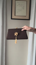 Load and play video in Gallery viewer, Vintage Upcyled Coco Brown Clutch Gold Tone French Flower Brooch Sourced from France Black Gold Tassel Fringe
